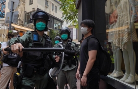 Riot police shield Hong Kong legislature as protests gather against anthem bill